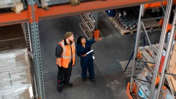 Warehouse operatives reviewing pallet stock in a third-party logistics facility